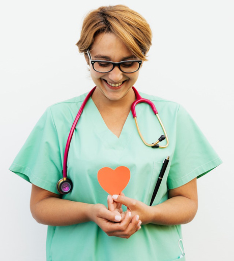 Doctor holding a paper cut out of a heart.